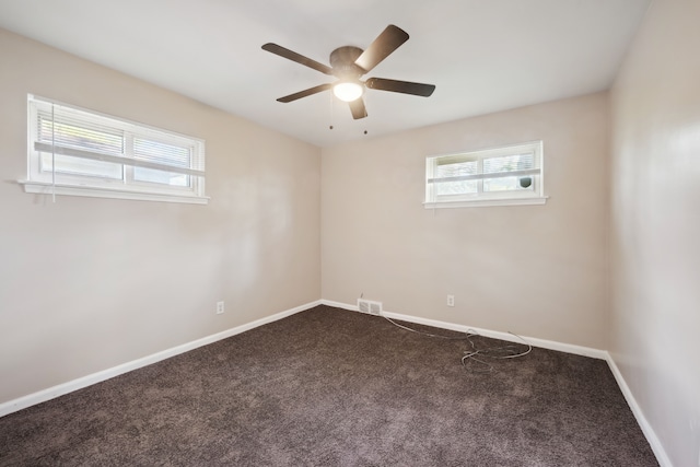 carpeted empty room featuring healthy amount of natural light, ceiling fan, and baseboards