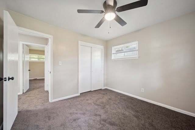 unfurnished bedroom with carpet, multiple windows, and baseboards