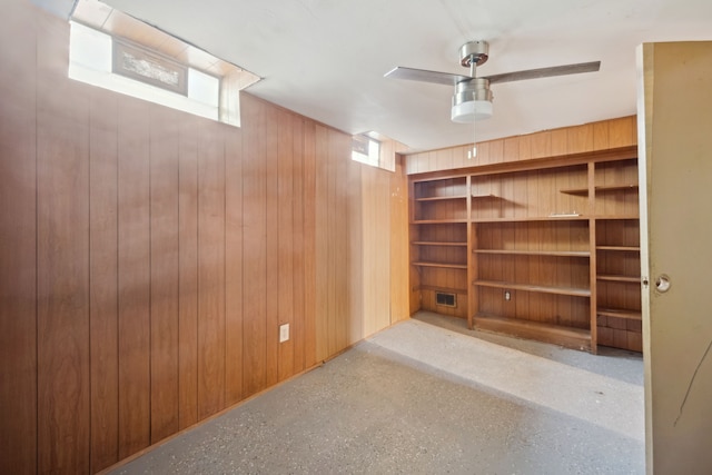 basement featuring wood walls