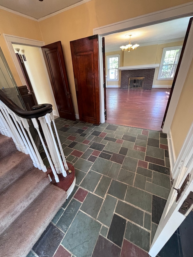 hall featuring dark hardwood / wood-style flooring, crown molding, and an inviting chandelier