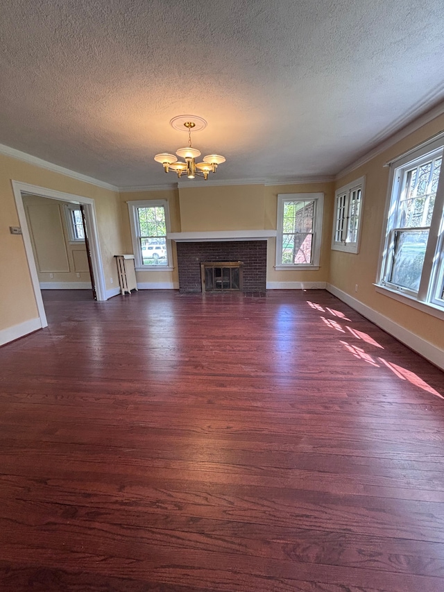 unfurnished living room featuring a textured ceiling, dark hardwood / wood-style floors, and crown molding