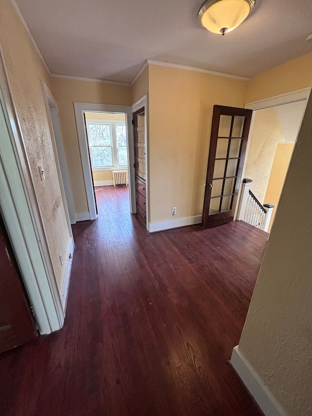 interior space with dark hardwood / wood-style flooring, radiator heating unit, and crown molding