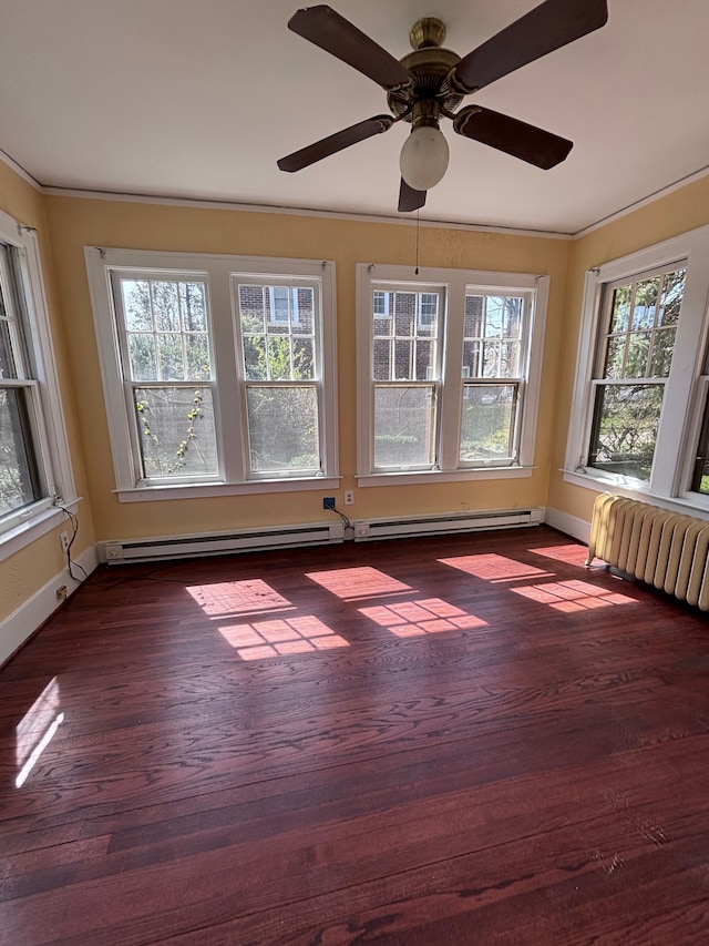 unfurnished sunroom with radiator heating unit, baseboard heating, plenty of natural light, and ceiling fan