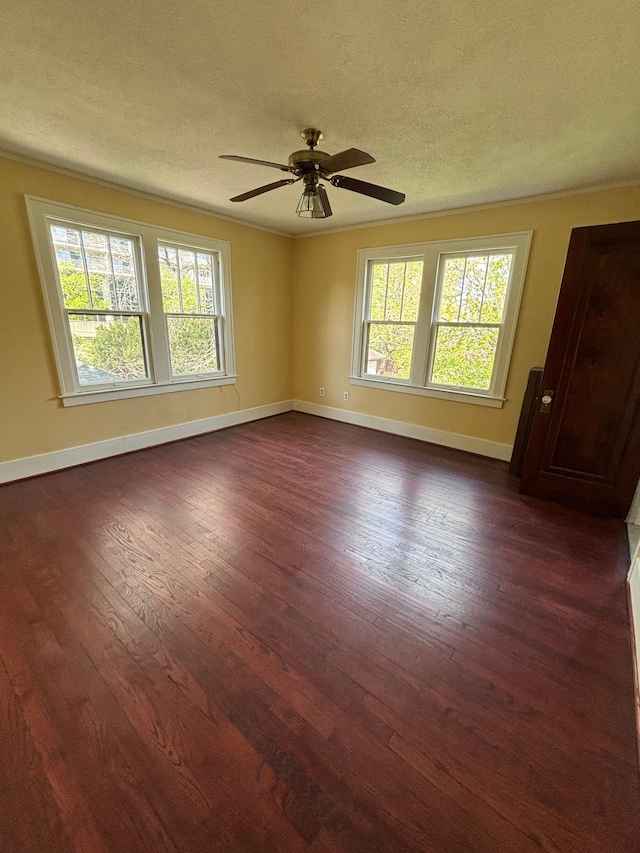 unfurnished room featuring dark hardwood / wood-style floors, ceiling fan, and a textured ceiling