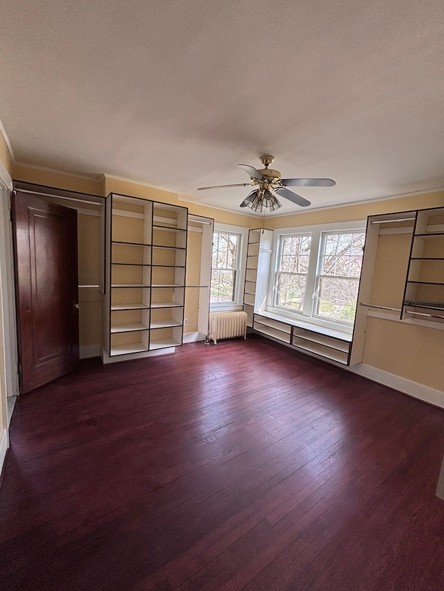 interior space featuring ceiling fan, dark hardwood / wood-style flooring, a textured ceiling, and radiator