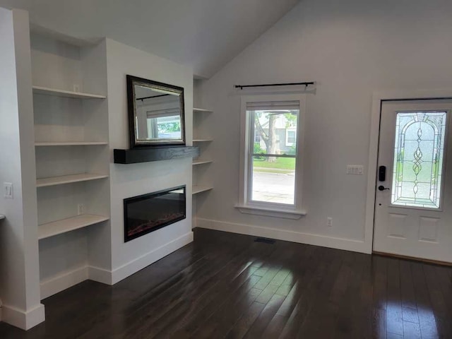 unfurnished living room with dark hardwood / wood-style flooring, built in features, and vaulted ceiling