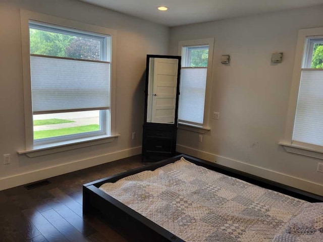 unfurnished bedroom with dark hardwood / wood-style flooring