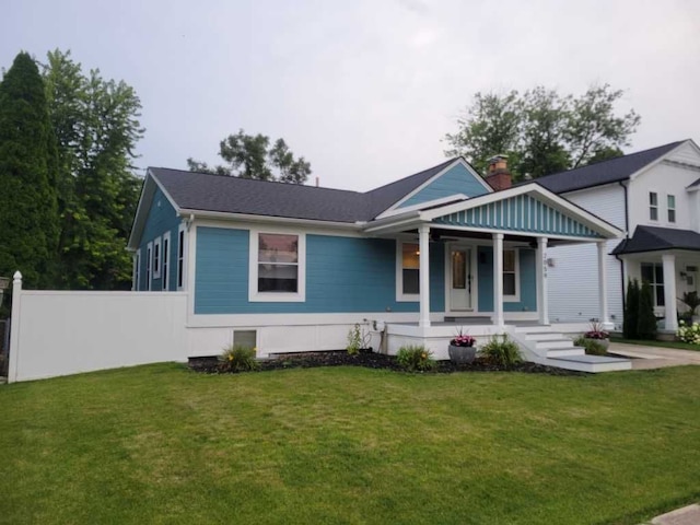 view of front of home with a porch and a front yard