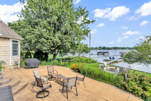 view of patio with a water view and grilling area