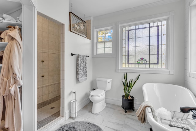 bathroom with toilet, ornamental molding, and shower with separate bathtub