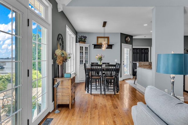 dining area with plenty of natural light and light hardwood / wood-style floors