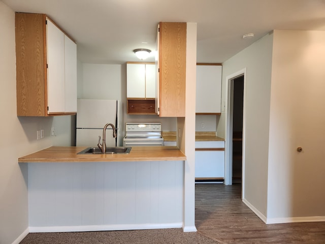 kitchen featuring white cabinetry, sink, electric range oven, dark hardwood / wood-style flooring, and white refrigerator