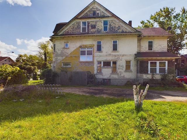 rear view of property with a yard