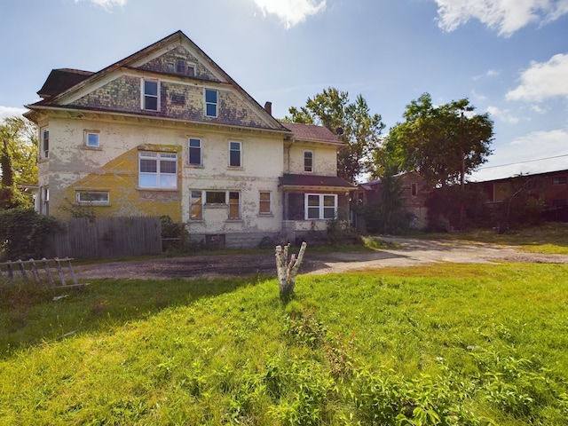back of property with a yard