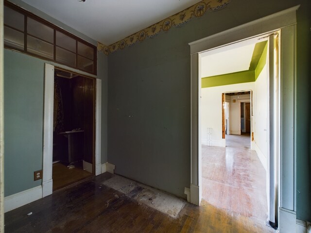 unfurnished bedroom featuring wood-type flooring and a closet
