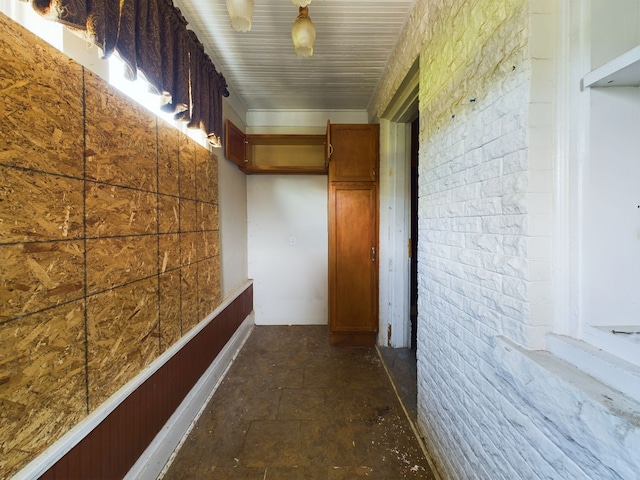 corridor featuring brick wall