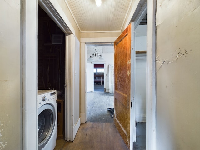 laundry area with hardwood / wood-style flooring, washer / dryer, and crown molding