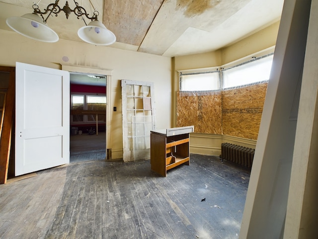 interior space with radiator heating unit and dark wood-type flooring