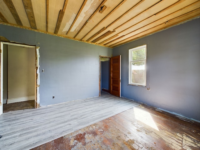 empty room with hardwood / wood-style flooring