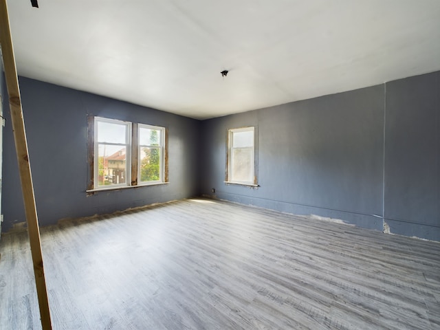 unfurnished room with light wood-type flooring