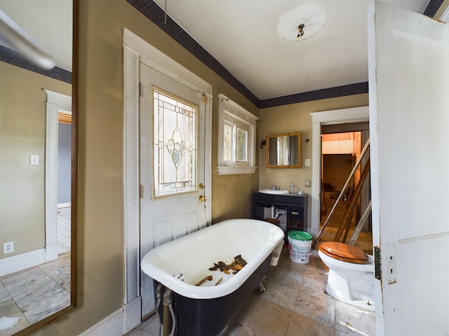 bathroom with toilet, a tub, and sink