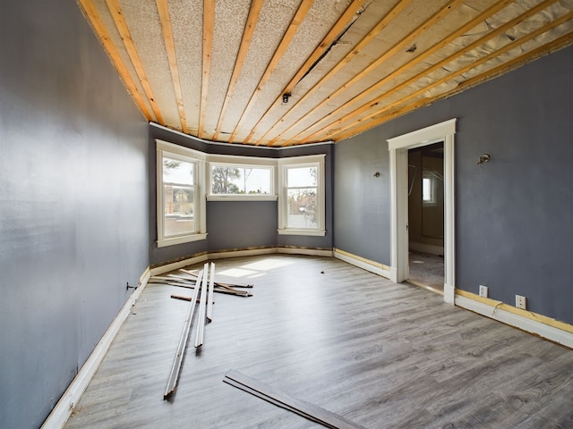 unfurnished room with wood-type flooring