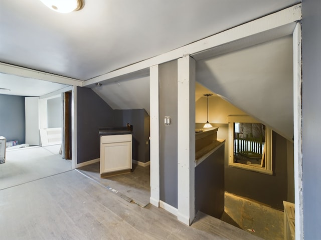 bonus room with light hardwood / wood-style flooring and vaulted ceiling