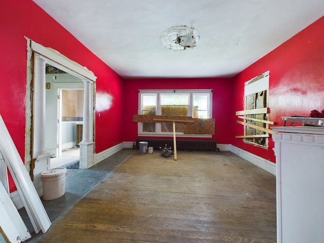 miscellaneous room featuring radiator and dark wood-type flooring