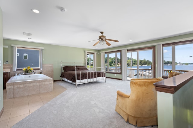 1794 S Hughes Rd, Brighton, MI 48114 - bedroom with access to outside, a water view, light tile patterned floors, light carpet, and recessed lighting