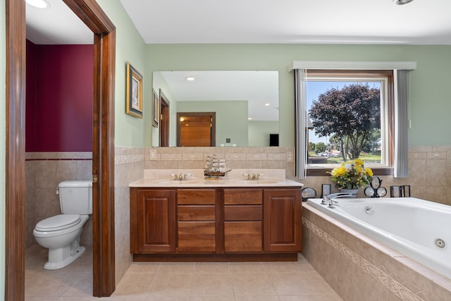 1794 S Hughes Rd, Brighton, MI 48114 - bathroom with tile patterned flooring, double vanity, a tub with jets, tile walls, and a wainscoted wall
