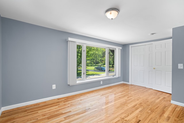 1794 S Hughes Rd, Brighton, MI 48114 - unfurnished bedroom with wood finished floors and a closet