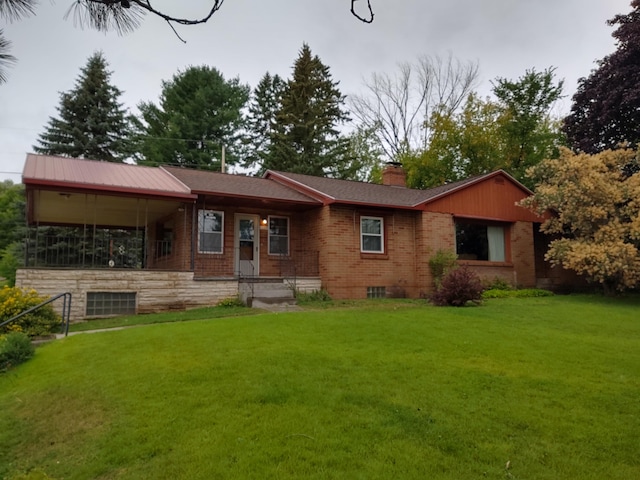 42294 Willson Memorial Dr, Chassell, MI 49916 - ranch-style house with brick siding, a front yard, and a chimney