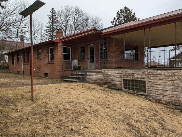 42294 Willson Memorial Dr, Chassell, MI 49916 - rear view of property with a chimney, metal roof, a yard, brick siding, and crawl space