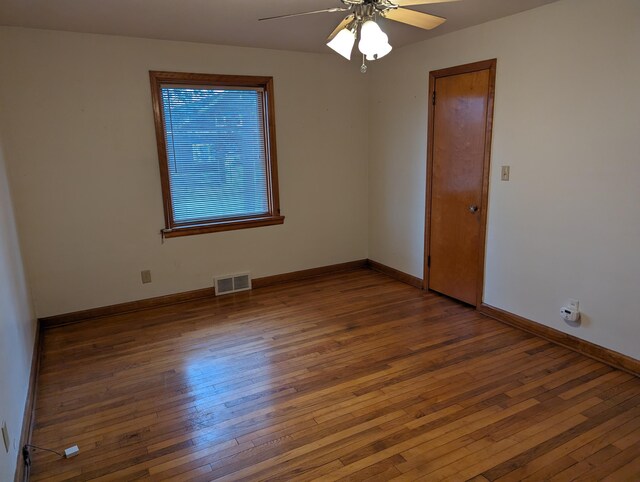 42294 Willson Memorial Dr, Chassell, MI 49916 - spare room with wood-type flooring, a ceiling fan, and baseboards