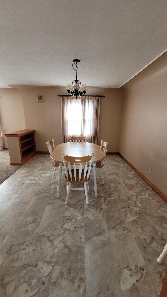 42294 Willson Memorial Dr, Chassell, MI 49916 - dining area featuring a chandelier and baseboards