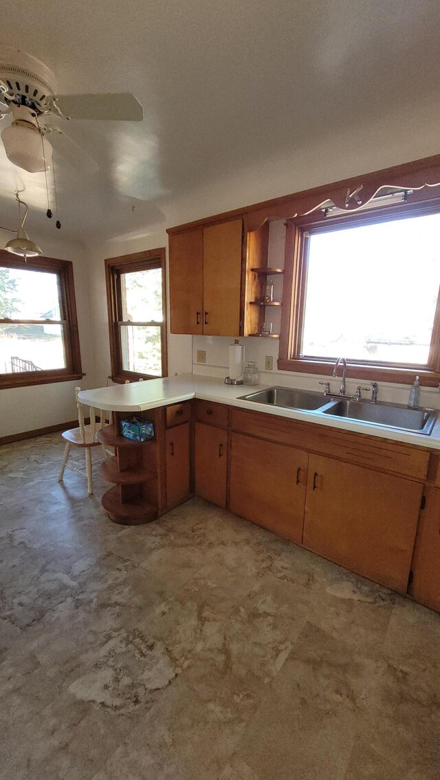 42294 Willson Memorial Dr, Chassell, MI 49916 - kitchen with open shelves, a sink, light countertops, a peninsula, and a ceiling fan