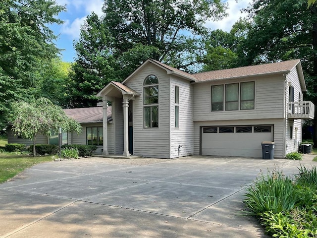 view of front of property featuring central AC unit and a garage