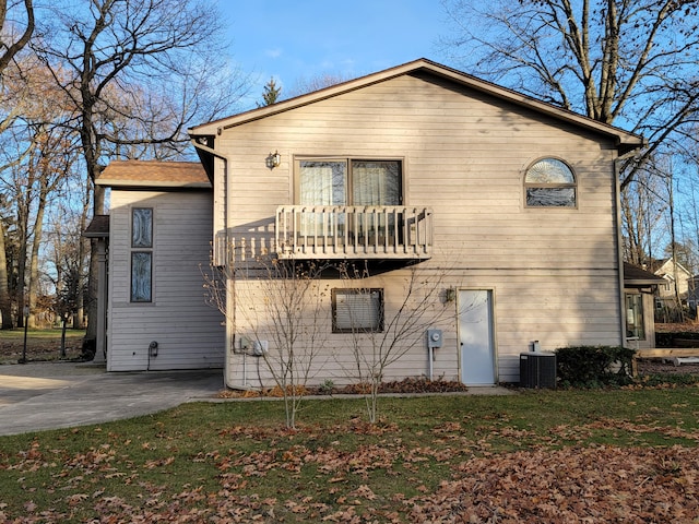 back of property featuring a balcony and central air condition unit