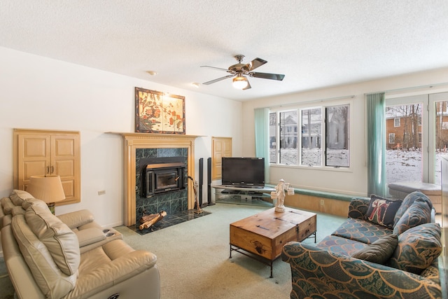 carpeted living room featuring ceiling fan and a textured ceiling