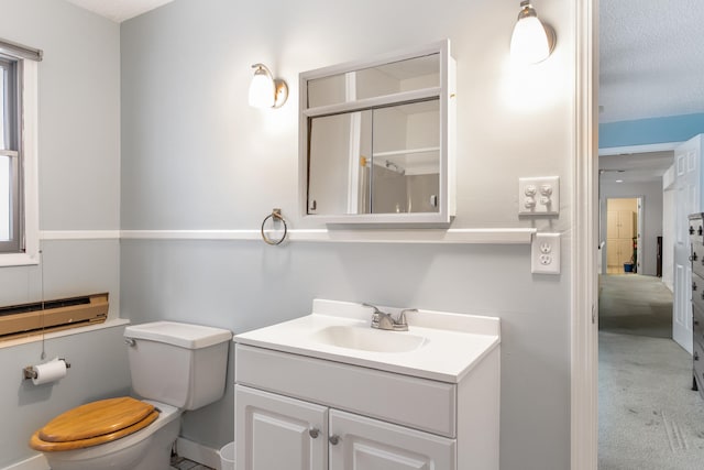 bathroom with vanity, a textured ceiling, and toilet