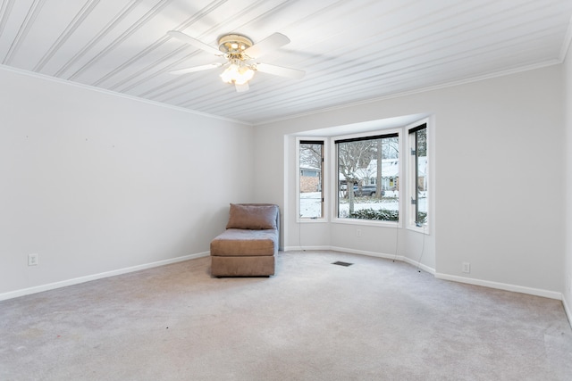 unfurnished room featuring light carpet, ceiling fan, and ornamental molding