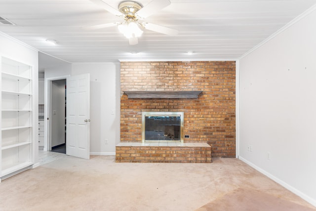 unfurnished living room with a brick fireplace, light carpet, ceiling fan, and ornamental molding