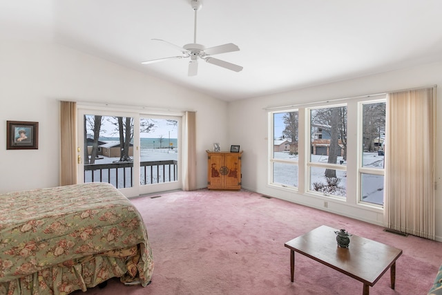 bedroom featuring carpet flooring, vaulted ceiling, multiple windows, and ceiling fan