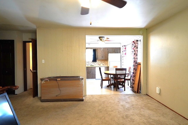 carpeted dining space featuring ceiling fan