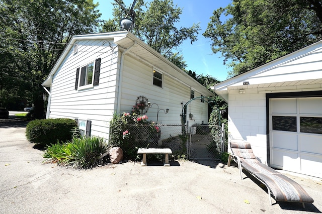 view of side of home featuring an outbuilding and a garage