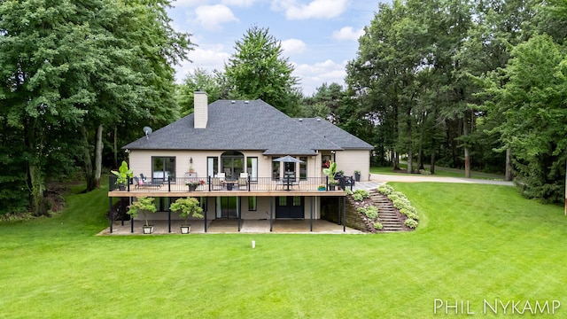 15111 Ransom St, Holland, MI 49424 - back of house featuring a wooden deck, a lawn, a chimney, and a patio area