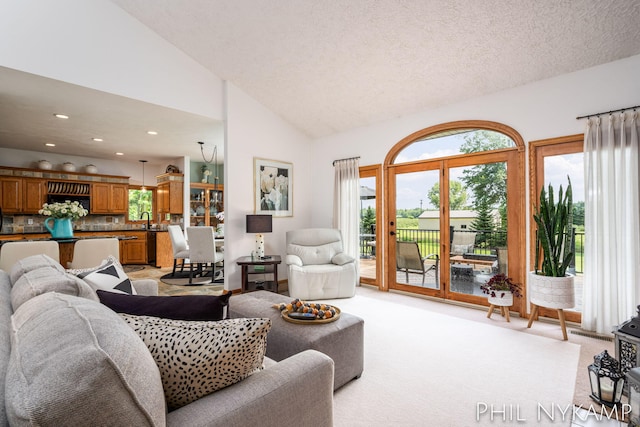 15111 Ransom St, Holland, MI 49424 - living room with vaulted ceiling, a textured ceiling, light carpet, and recessed lighting