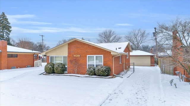 exterior space with a garage and an outbuilding