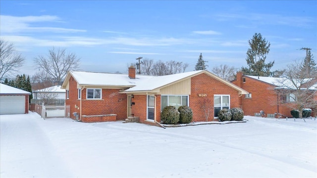 view of front of property featuring a garage and an outbuilding