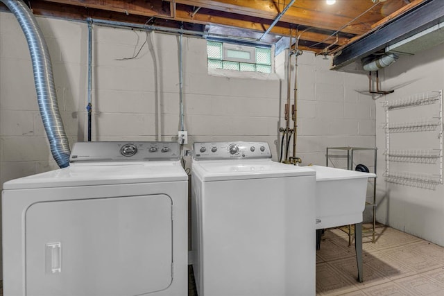 laundry area featuring washing machine and dryer and sink